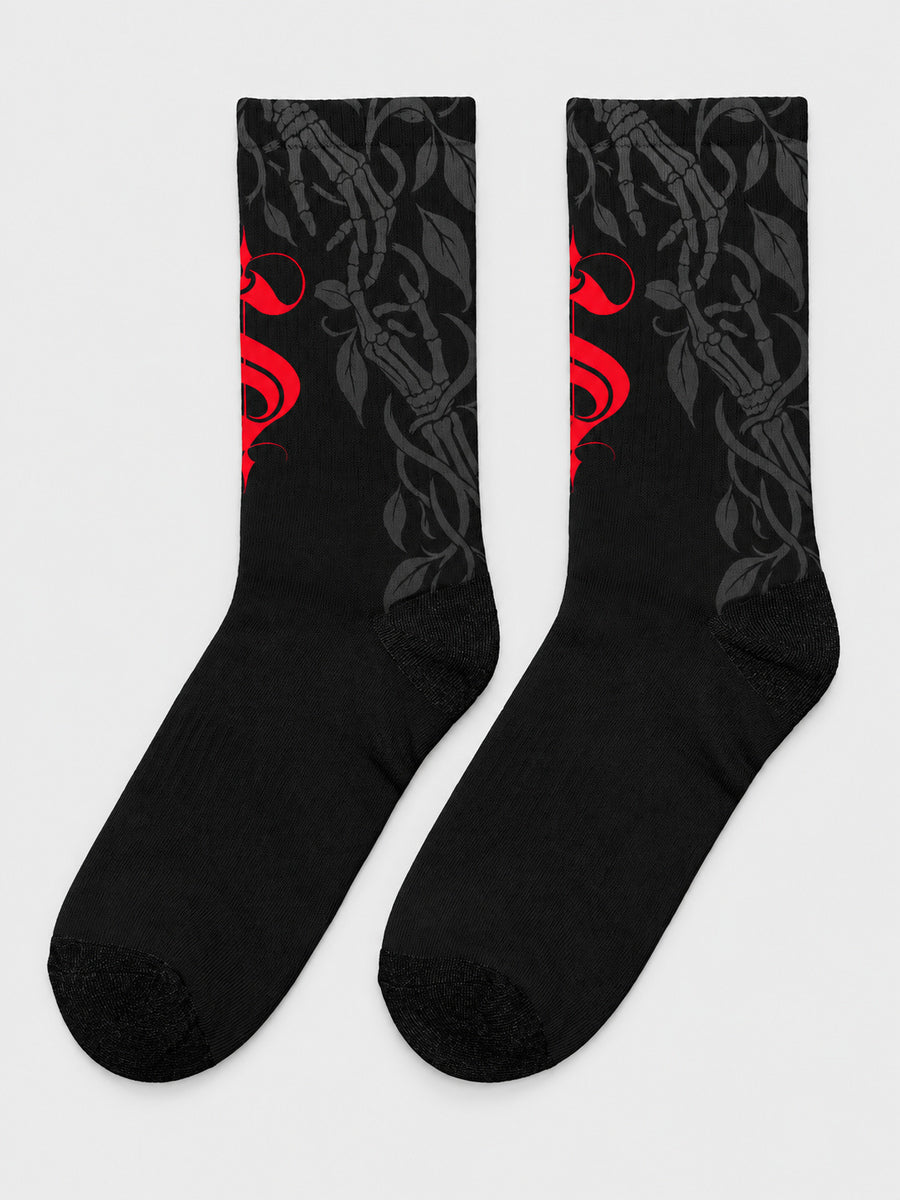 Synthesis Death Grip socks — complete supplier-style pair on gray, outer patterned view, black with red ornate S and dark gray skeletal hands with leaves.
