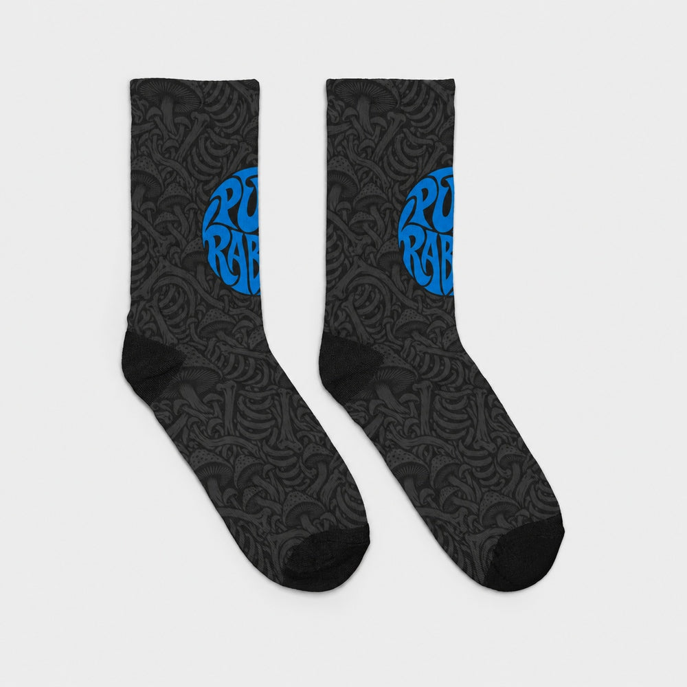 Product-only opposite side view of the pair: black crew socks with charcoal mushroom and skeletal artwork and a blue circular Punkrabbits logo.