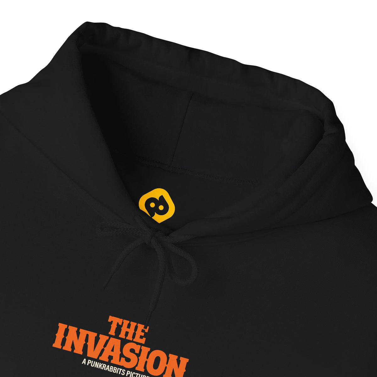 The Invasion black hoodie close-up of drawstring hood, neckline and orange The Invasion chest lettering