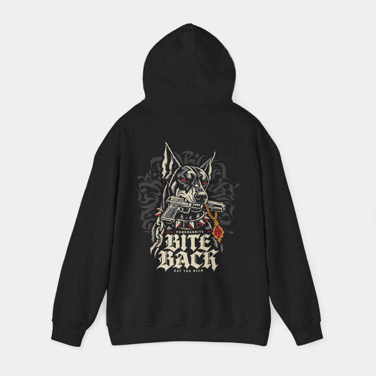 Bite Back black hoodie with hood raised, back view showing a Doberman with red eyes and a spiked collar, gripping an illustrated handgun, beside a gold chain and red pendant; Punkrabbits, Bite Back and Eat the Rich lettering complete the composition.