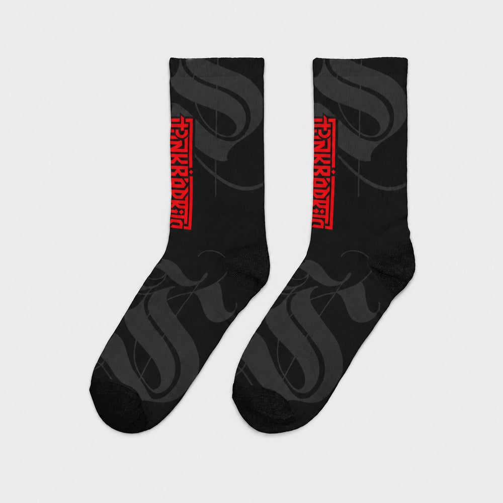 Product-only side view of the pair: black crew socks with charcoal calligraphic strokes and a vertical red Punkrabbits wordmark.
