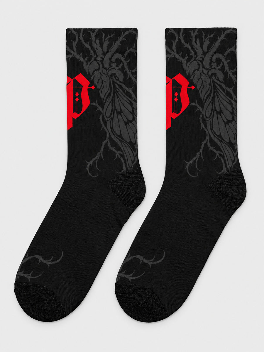 Synthesis Butterfly Roots socks — complete supplier-style pair on gray, outer patterned view, black with red Gothic P and dark gray butterfly roots.