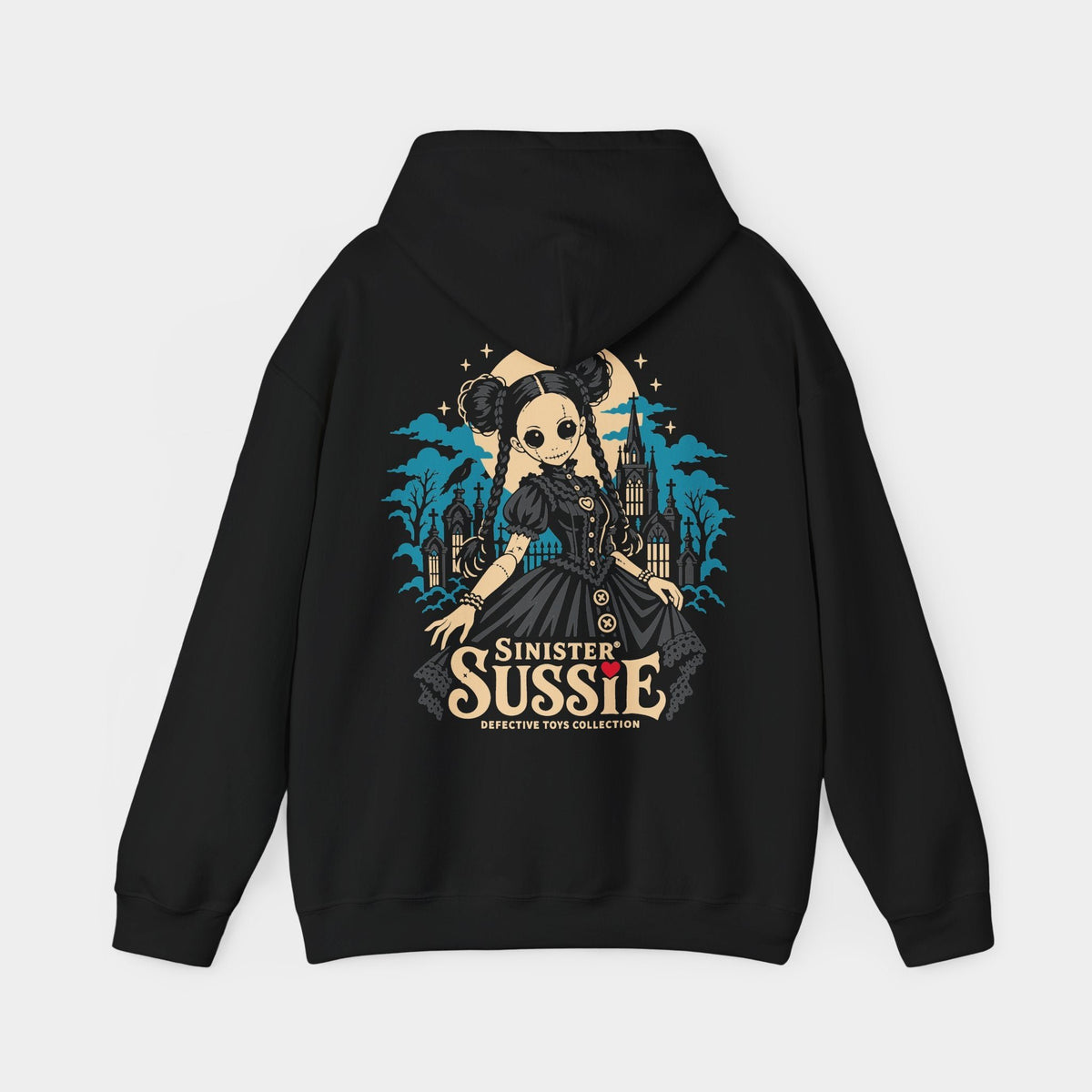 Sinister Sussie black hoodie, back view showing a stitched doll with twin hair buns, braids and a charcoal dress before a teal Gothic church and cemetery, with an ivory moon, raven and Sinister Sussie lettering.