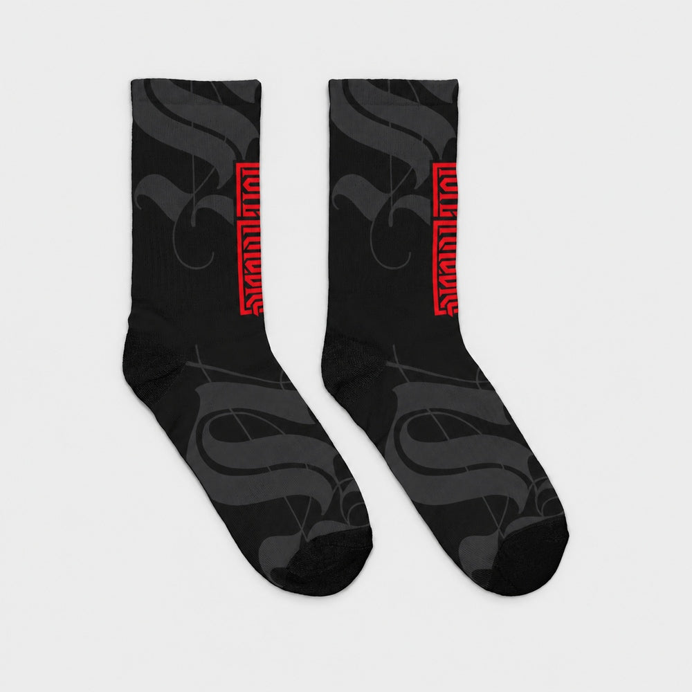 Product-only opposite side view of the pair: black crew socks with charcoal calligraphic strokes and a vertical red Punkrabbits wordmark.