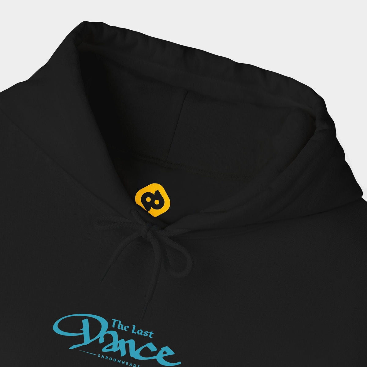 Last Dance black hoodie neckline and chest close-up showing blue The Last Dance script with small Shroomheads lettering.