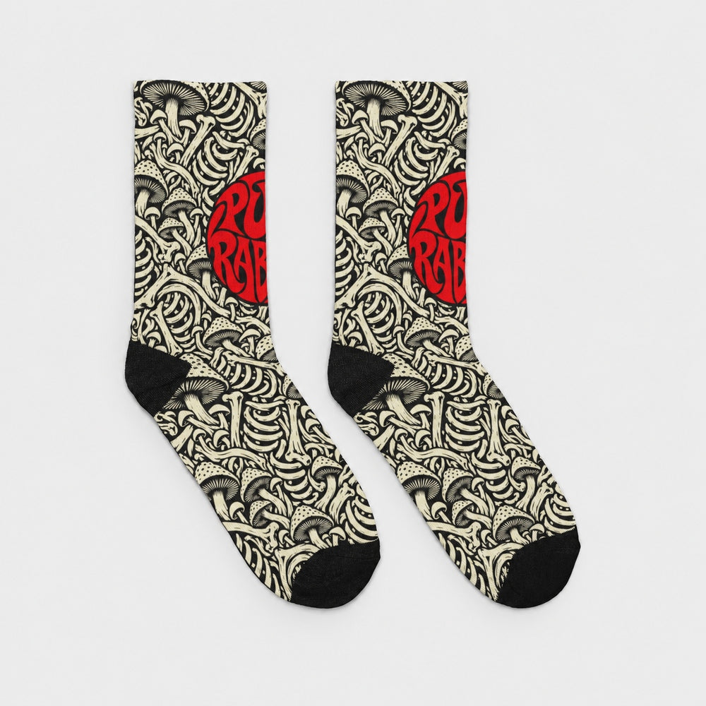 Product-only opposite side view of the pair: black crew socks with ivory mushroom and skeletal artwork and a red circular Punkrabbits logo.