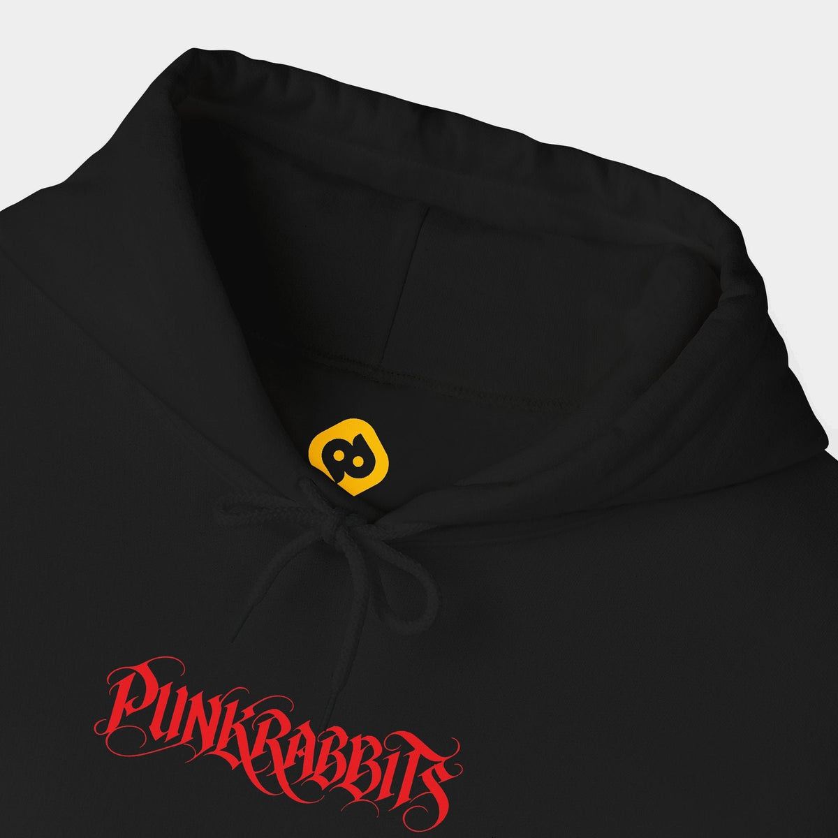 Ecstasis black hoodie neckline and chest close-up showing a compact red Punkrabbits calligraphic wordmark.