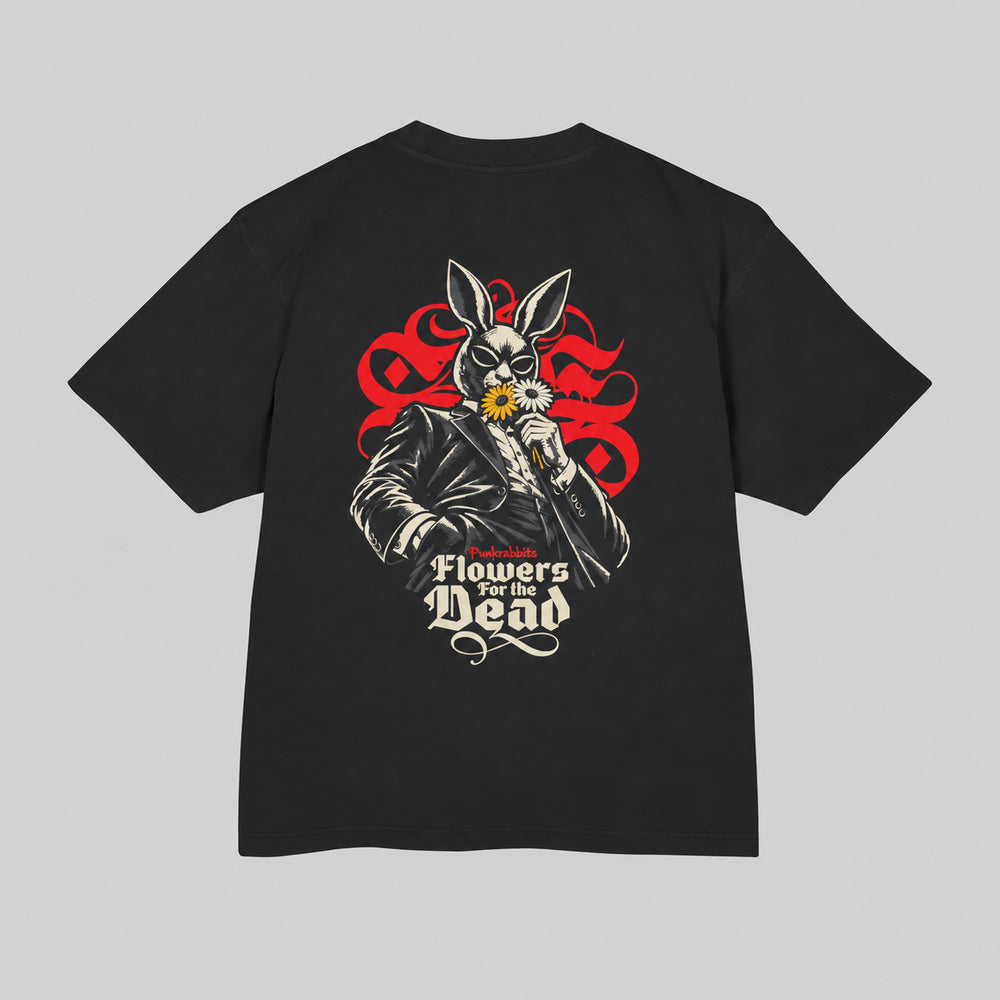 Back of black Flowers for the dead Premium Boxy Tee with suited rabbit-masked figure holding yellow and ivory flowers.
