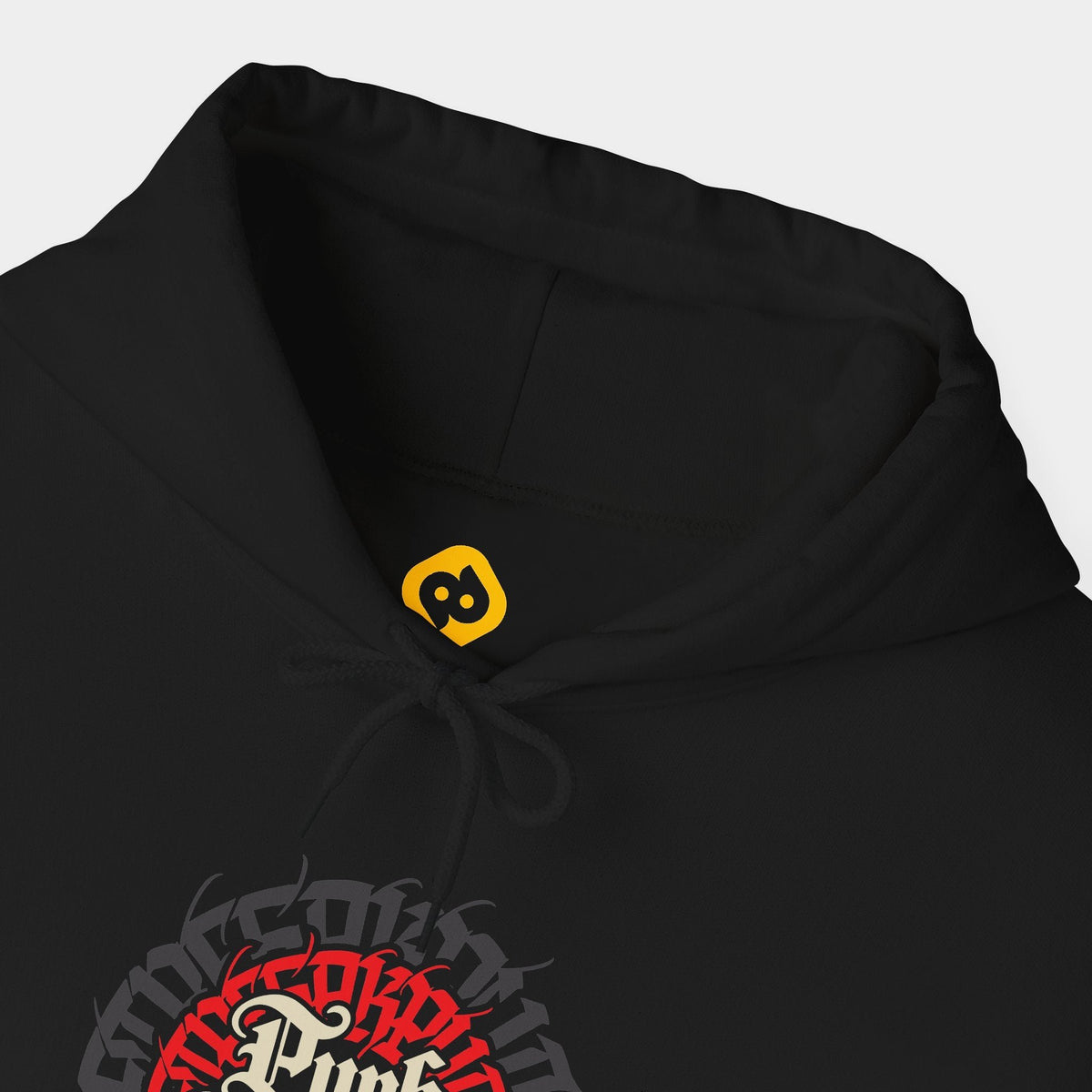 Succession black hoodie neckline and chest close-up showing cream Punk Rabbits blackletter inside a circular red and charcoal typographic emblem.