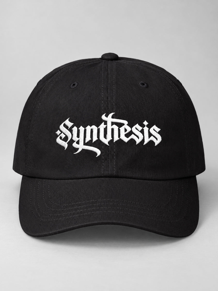 Black Synthesis Ritual cap with white Gothic embroidery, front studio view.