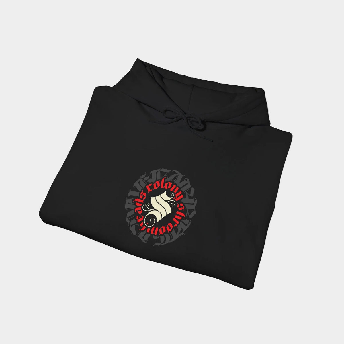 Colony black hoodie folded, showing a circular Colony Shroomheads crest in ivory and red over charcoal lettering.