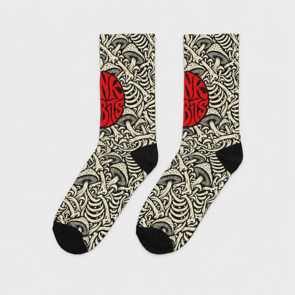 Product-only side view of the pair: black crew socks with ivory mushroom and skeletal artwork and a red circular Punkrabbits logo.
