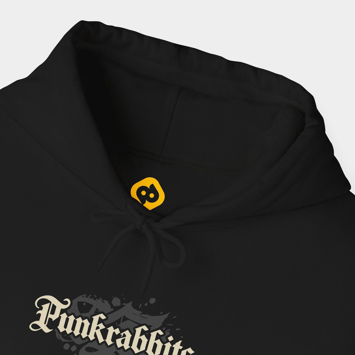 Hostile Takeover black hoodie neckline and chest close-up showing a cream Punkrabbits blackletter chest wordmark.