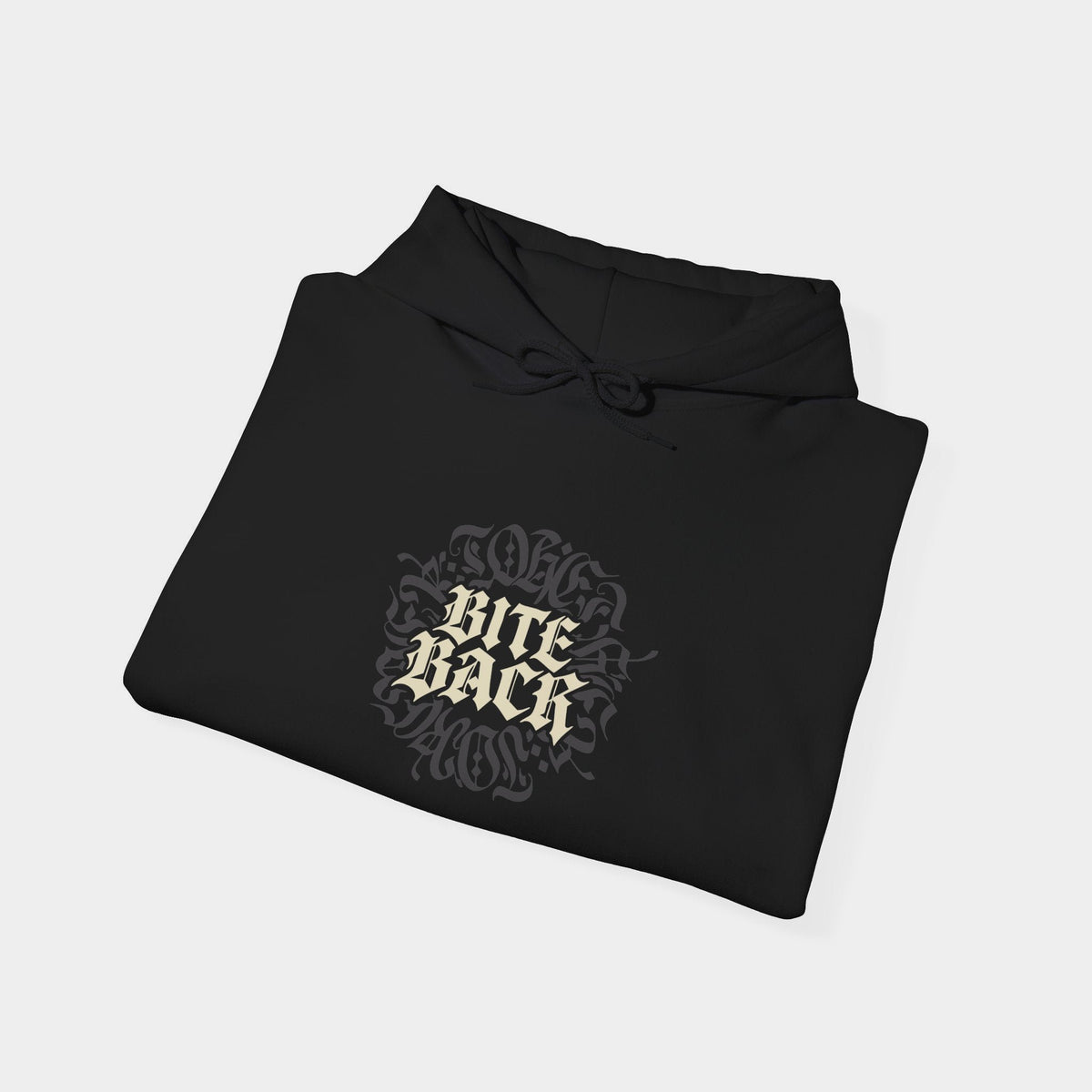 Bite Back black hoodie folded to show cream Bite Back blackletter in two stacked lines over a dark charcoal ornamental circle.