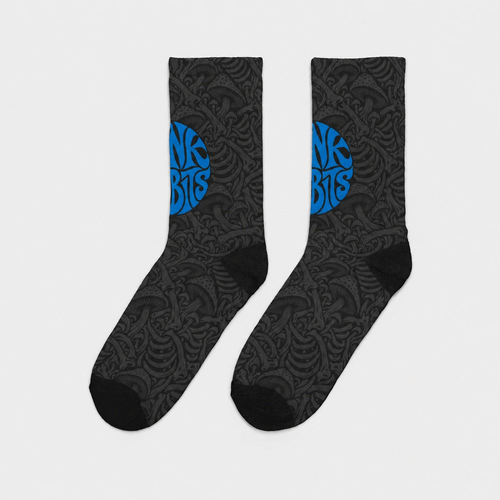 Product-only side view of the pair: black crew socks with charcoal mushroom and skeletal artwork and a blue circular Punkrabbits logo.