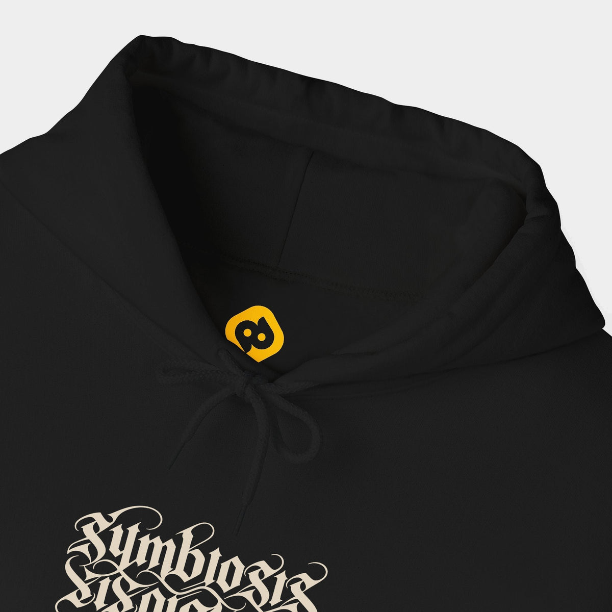 Symbiosis black hoodie neckline and chest close-up showing paired upright and inverted ivory Symbiosis lettering.