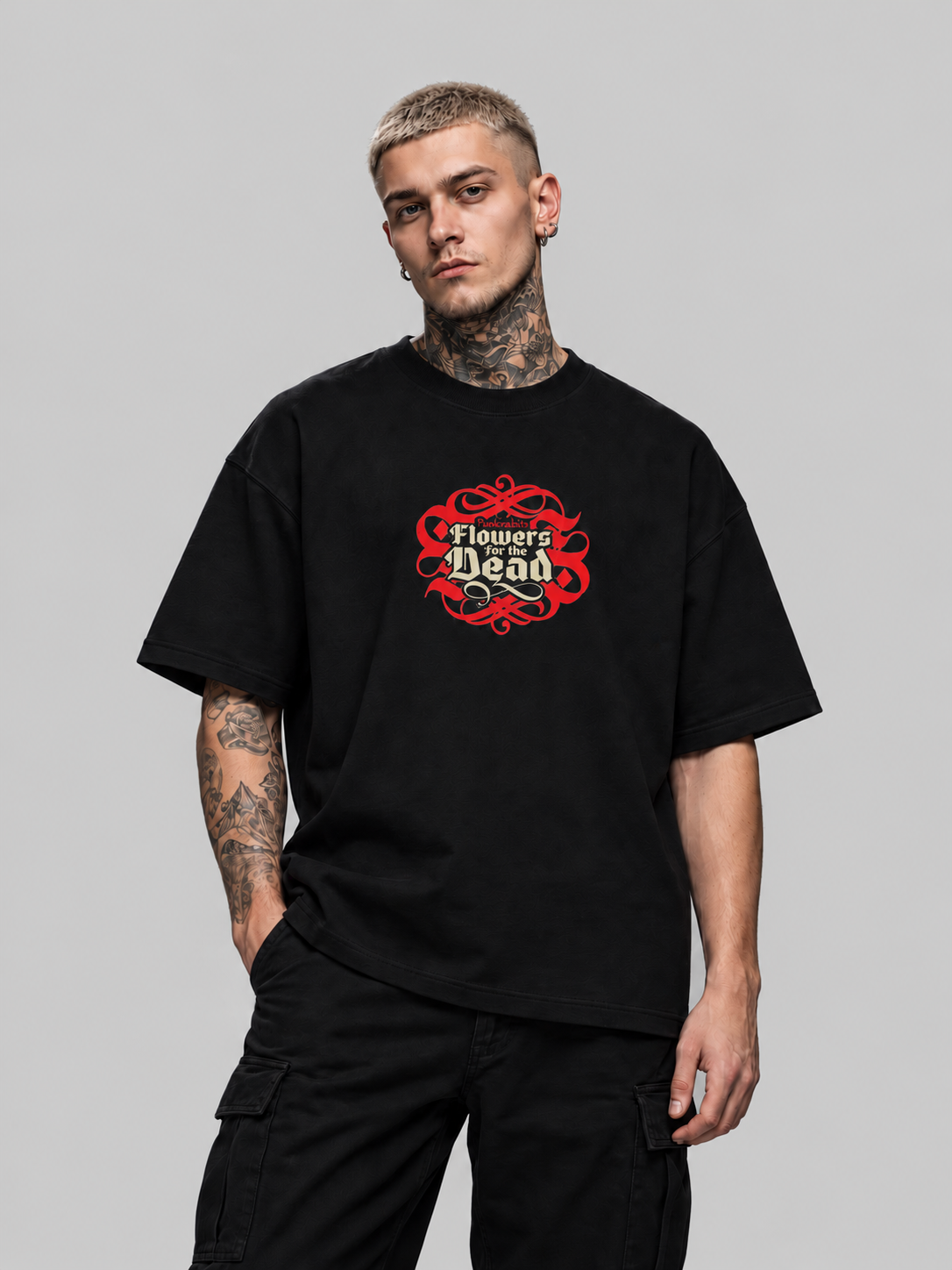 James wearing black Flowers for the dead Premium Boxy Tee, front view with ivory Gothic title and red ornament in a gray studio.
