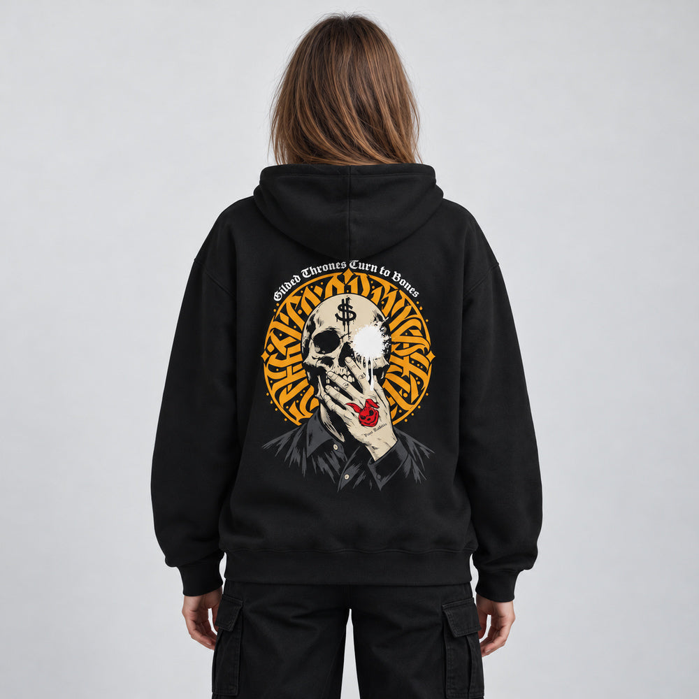 Mara wearing the black Gilded Thrones Turn to Bones hoodie, back view in a pale gray studio.