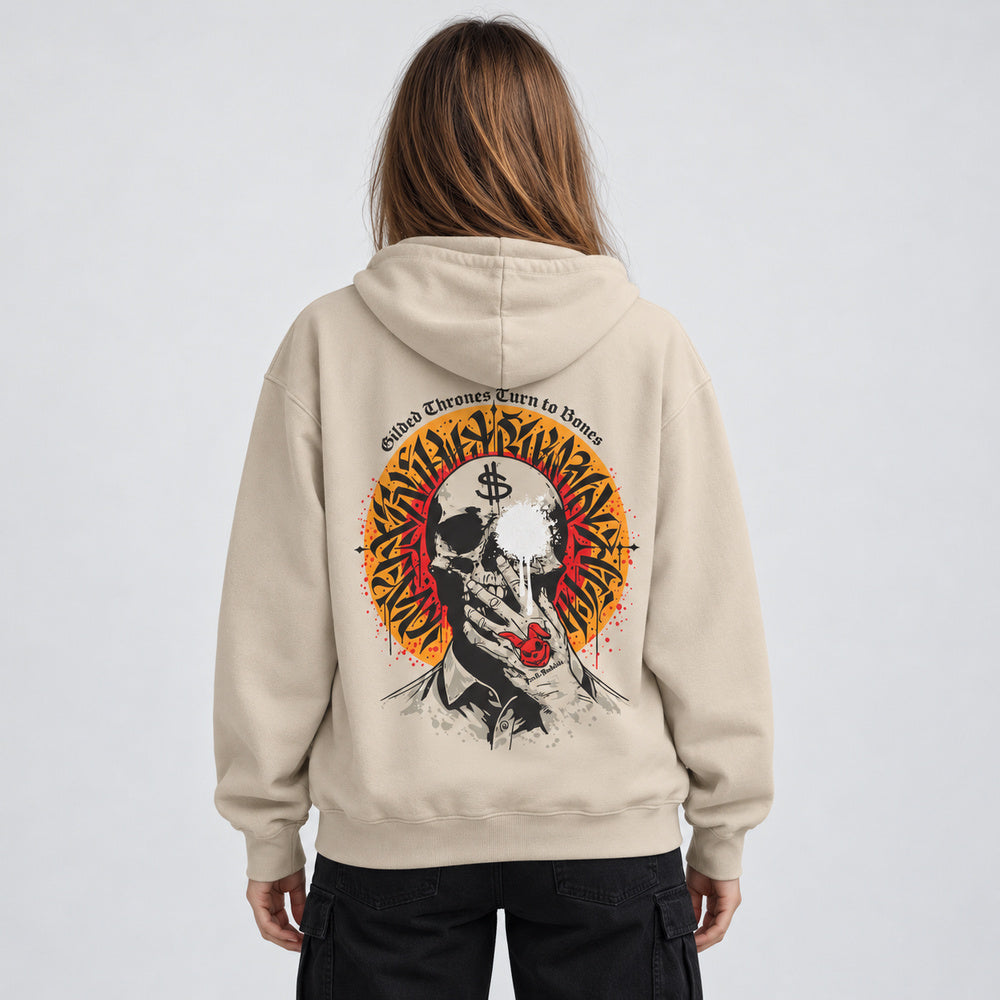 Mara wearing the Sand beige Gilded Thrones Turn to Bones hoodie, back view in a pale gray studio.