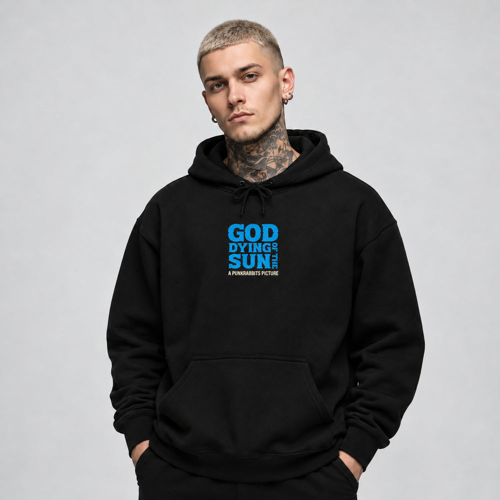 James wearing the God of the Dying Sun black Gildan 18500 hoodie, front view with blue God of the Dying Sun chest lettering