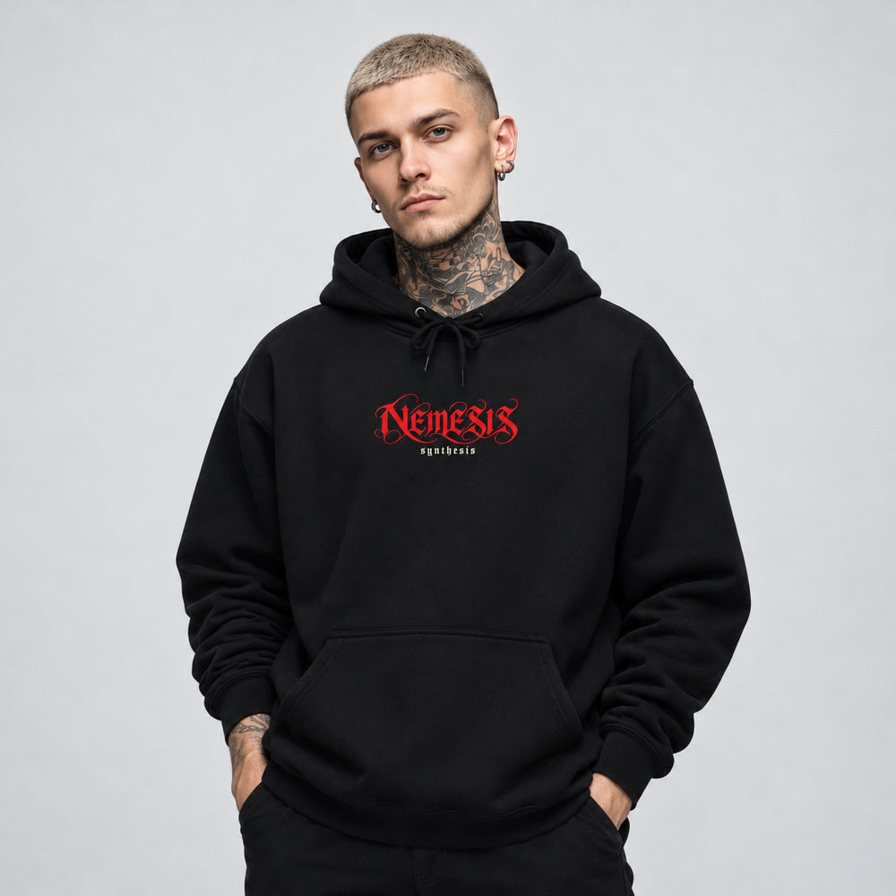 James wearing the black Nemesis hoodie, front view showing red Nemesis calligraphic lettering with small ivory Synthesis text.