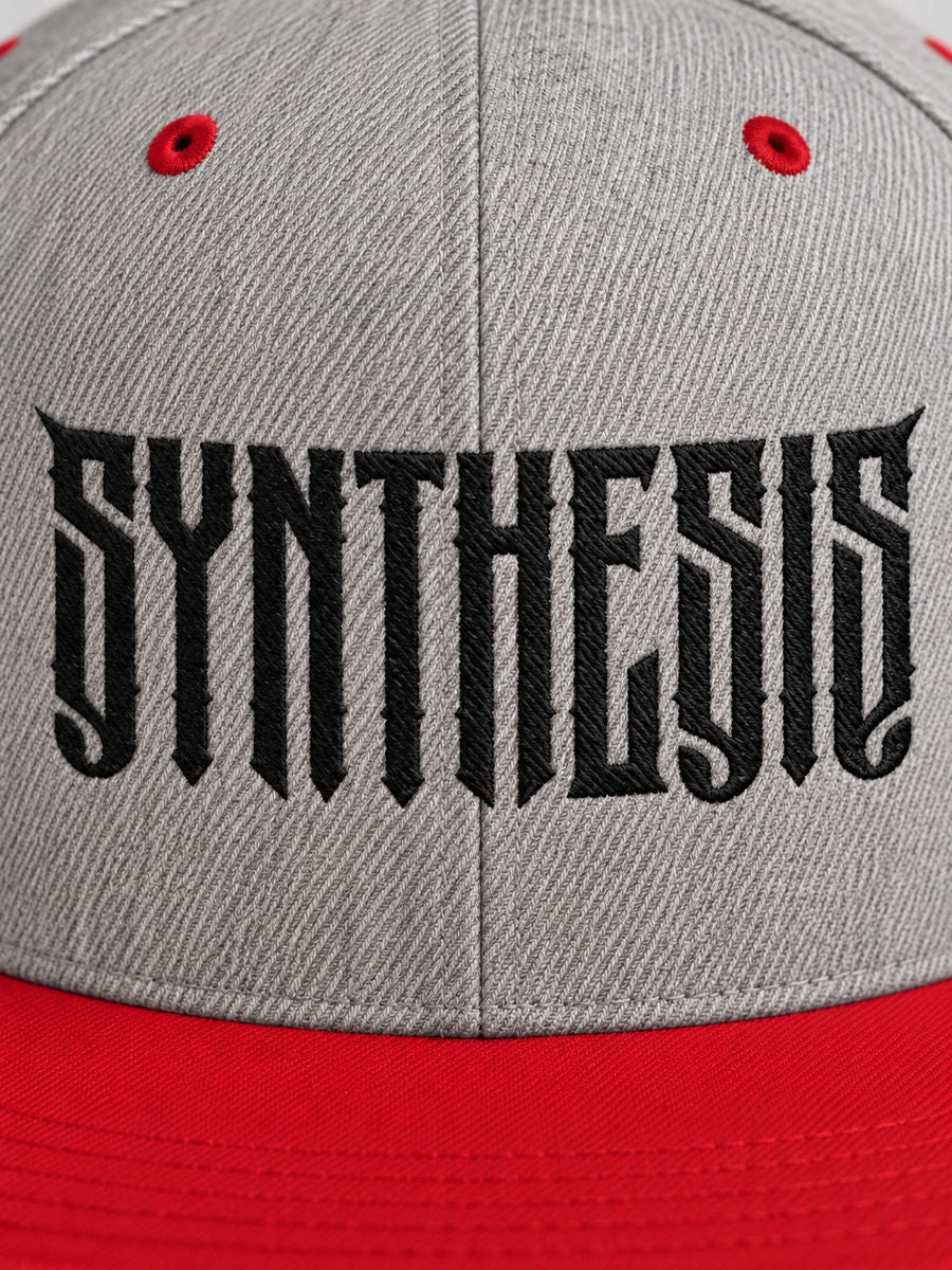 Close-up of black angular Synthesis embroidery on the Heather Grey and Red Blackout snapback.
