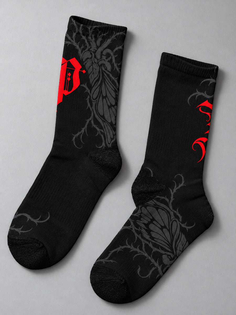 Synthesis Butterfly Roots socks — styled pair flat lay, both verified printed views, black with red Gothic P and dark gray butterfly roots.