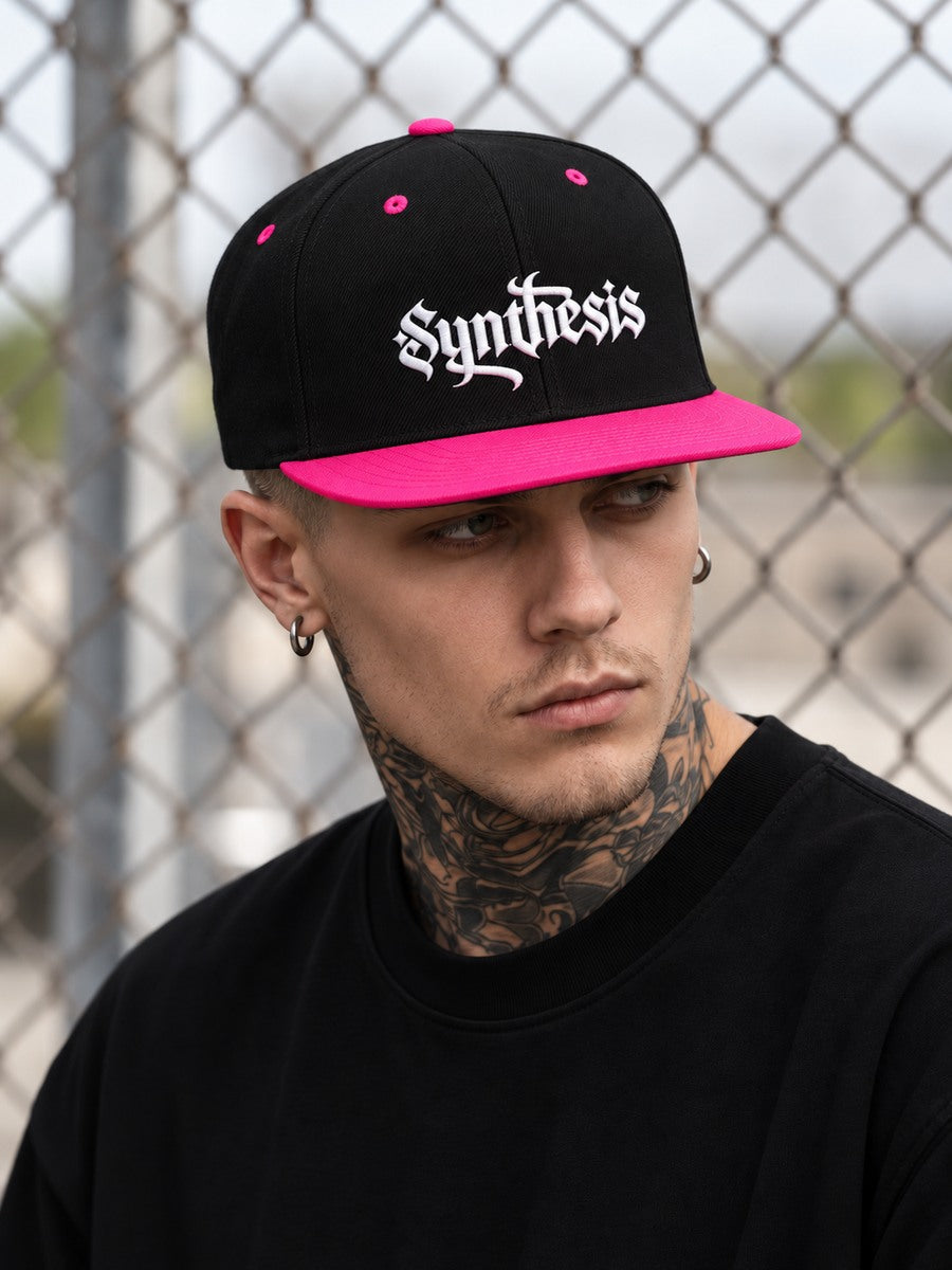 James wearing the Black/Neon Pink Synthesis Doomed snapback low at the temples, looking away with the flat pink bill and white embroidery visible.