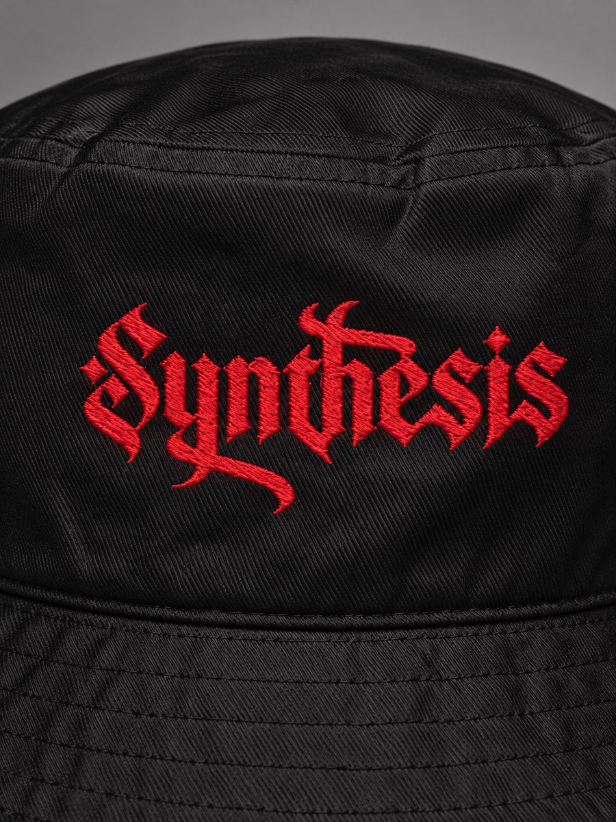 Close-up of red Gothic Synthesis embroidery and black cotton twill on the Red Ritual bucket hat.