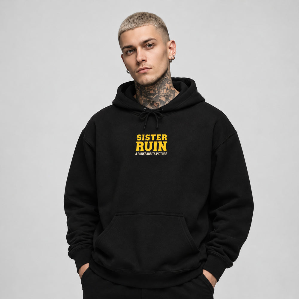 James wearing the Sister Ruin black Gildan 18500 hoodie, front view with yellow Sister Ruin chest lettering