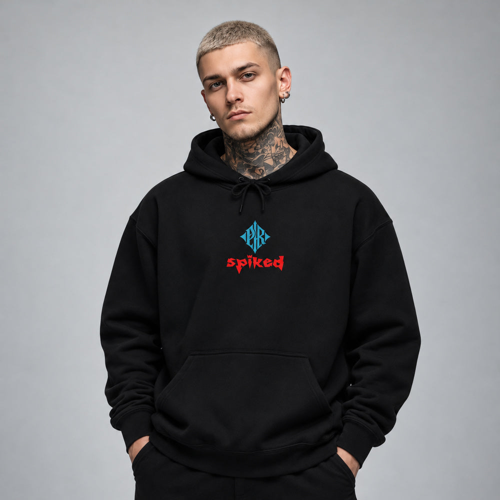 James wearing the black Spiked hoodie, front view showing a blue PR diamond above red Spiked lettering.