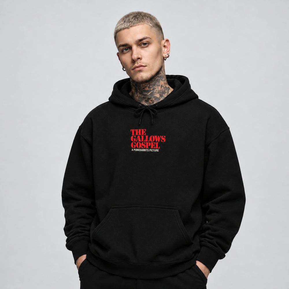 James wearing The Gallows Gospel black Gildan 18500 hoodie, front view with red The Gallows Gospel chest lettering