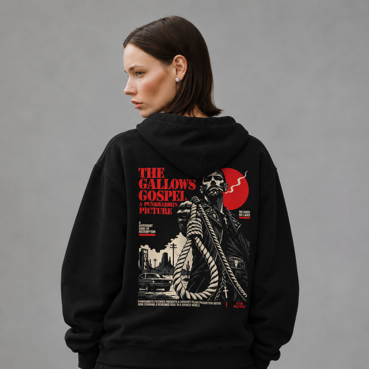 Mara wearing The Gallows Gospel black hoodie, back view — styled mockup