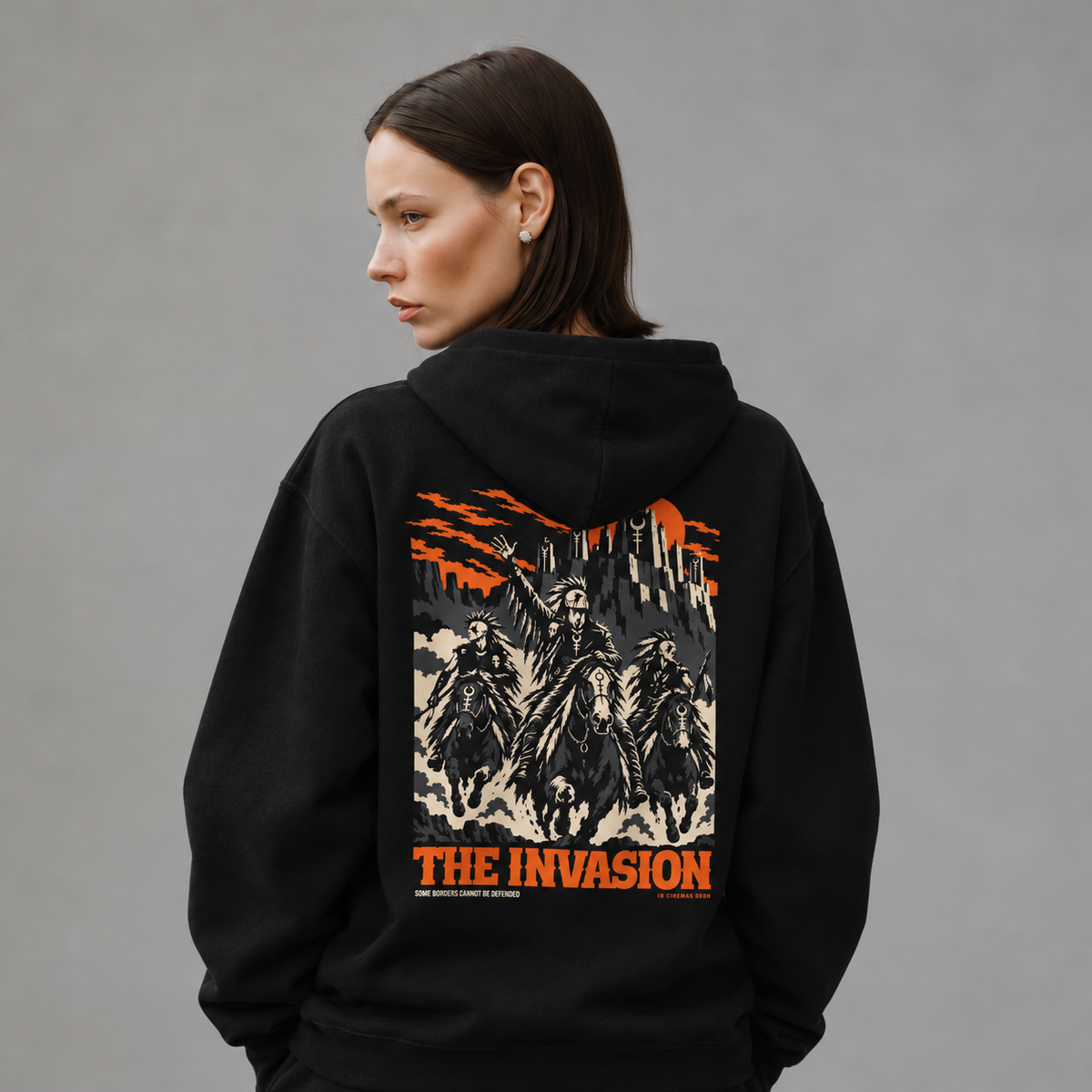 Mara wearing The Invasion black hoodie, back view — styled mockup